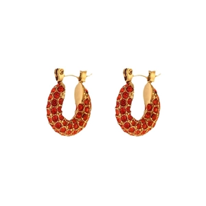 U-shaped gold stainless steel earrings with red zircon stones on a white background