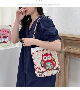 Detailed view of owl jacquard embroidery on cream canvas bag with ethnic strap