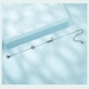 Detailed macro view of S925 sterling silver dachshund and dog paw charm bracelet