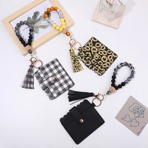 Beaded wristlet keychain with leather tassel and card holder set in various floral patterns