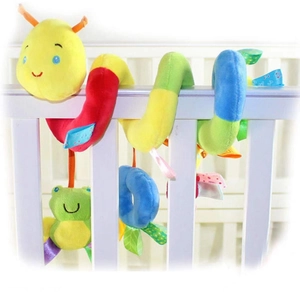 Detail of colorful plush caterpillar stroller toy with hanging frog and rattle on crib