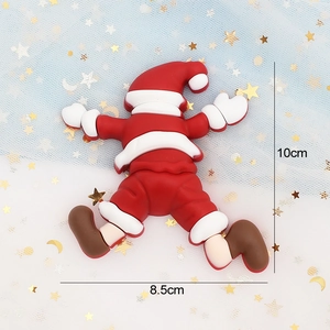 Detail of soft glue Santa Claus cake topper decoration with dimensions 10cm by 8.5cm