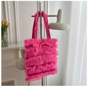 Detailed view of a vibrant pink ruffle mesh tote bag featuring a layered cake skirt design