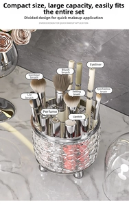 Detail view of transparent rotating makeup organizer with silver metal trim and partitions