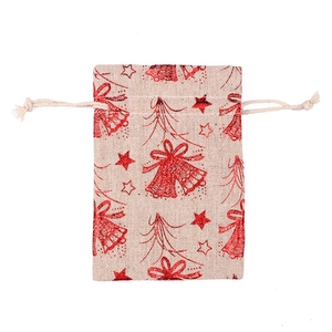 Detailed view of linen drawstring gift bag with red Christmas bells and star patterns
