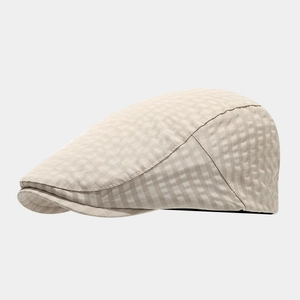 Detail of British style beige plaid flat cap fabric texture and fine stitching