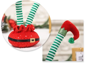 Close-up of red sequins and green striped knit fabric on Christmas elf leg decorations