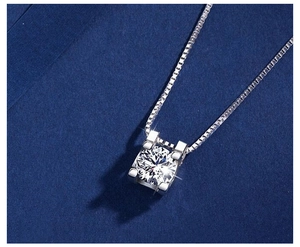 Macro shot of silver bull head pendant with round cut zircon on a classic box chain