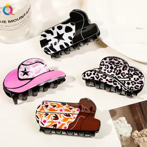 Detail of western hat and boot shaped acrylic hair claws with cow and star patterns