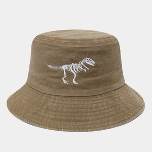 Close-up of white dinosaur skeleton embroidery on a vintage washed khaki cotton bucket hat