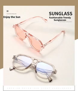 Detail view of retro oversized pilot sunglasses with pink and grey transparent frames