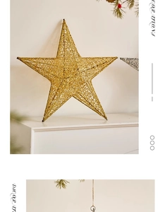 Close-up of golden glitter star ornament on white mantel with pine branches for Christmas