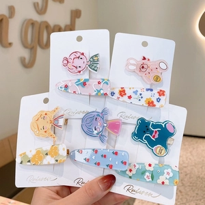 Detail of cute acrylic cartoon hair clips for girls featuring bear and rabbit patterns