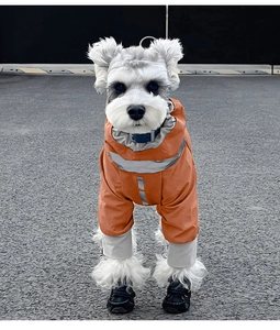 Close-up of bright orange waterproof dog raincoat with reflective safety stripes