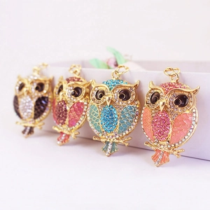 Colorful crystal owl keychains in four vibrant color combinations with gold metal finish