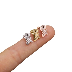 Three dinosaur stud earrings in gold, silver, and rose gold with zircon stones