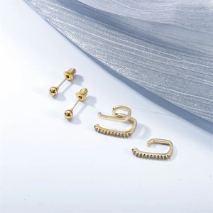 Minimalist gold ear cuff set with cubic zirconia on elegant light blue fabric