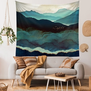 Close-up of bohemian wall tapestry with abstract blue mountains in a modern living room