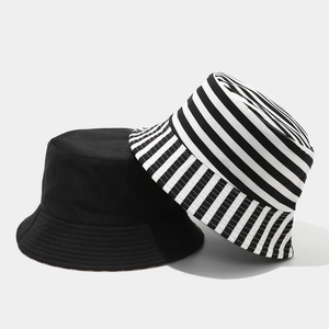 Detail of black and striped canvas bucket hats with flat tops for sun protection