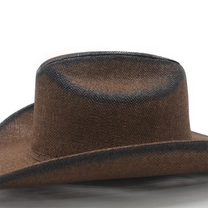 Detail of hand-woven brown straw cowboy hat with black spray-painted edges and texture