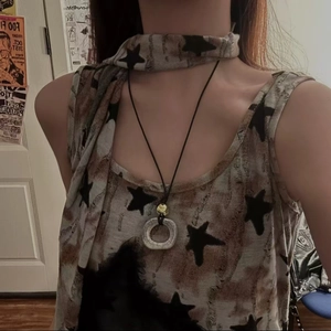 Detailed close-up of a Zen-style vintage ceramic ring pendant on a black cord necklace