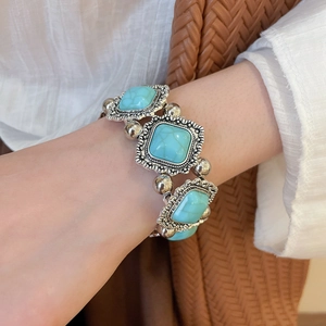 Detailed close-up of retro geometric acrylic bracelet with vintage silver-toned embossed frame