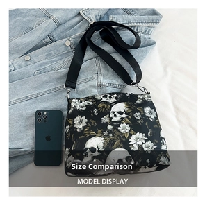 Nylon tote bag size comparison with a smartphone showing gothic skull and floral prints