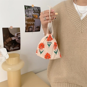 Detail of floral drawstring pouch with red flowers and branded Sozakka label