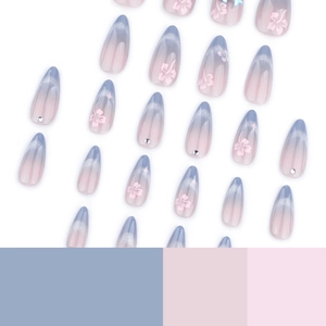 Blue and pink gradient almond press-on nails with floral patterns and rhinestones