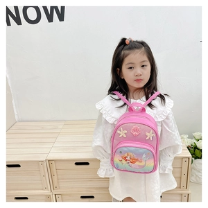 Close-up of pink mermaid backpack with sequins and shell details worn by a child