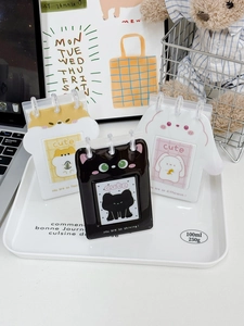 Three cute cartoon PVC card holders with cat, hamster, and rabbit designs on a desk