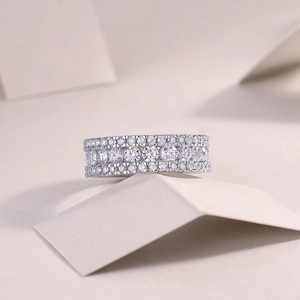 Macro view of triple-row silver moissanite eternity ring with brilliant round-cut stones