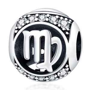 Macro view of silver Virgo zodiac charm with sparkling cubic zirconia stones and cutout