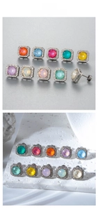 Detailed macro view of colorful round stone stud earrings in square diamond frames