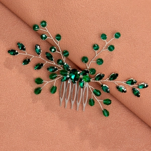 Detail of silver leaf hair comb with emerald green teardrop crystals and faceted beads