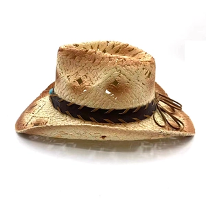 Detailed macro view of woven straw cowboy hat with turquoise bead and leather band decoration