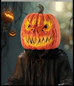 Detailed view of Halloween pumpkin head mask with ragged black cloak in dark forest