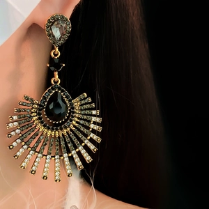 Close-up of vintage fan-shaped earrings with black crystals and teardrop tassels