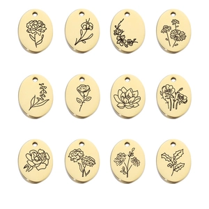 Detail view of 12 gold oval birth flower pendants with intricate floral engravings