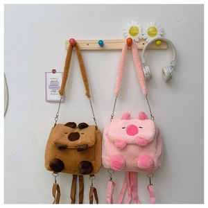 Detail of cute plush Capybara and pink pig bags with soft texture and chain straps
