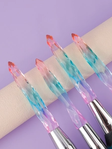 Detailed macro view of iridescent crystal makeup brush handles with multi-faceted gradient design