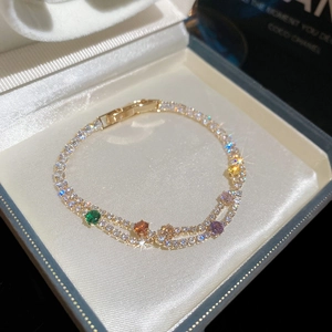Close-up of 18k gold plated double-layer bracelet with colorful sparkling cubic zirconia