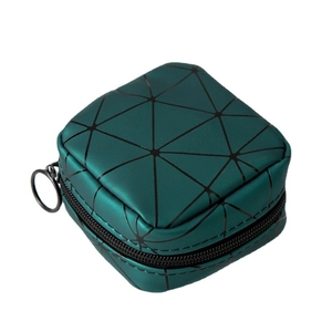 Mini PU leather makeup bag with green geometric patterns and ring zipper on white backdrop