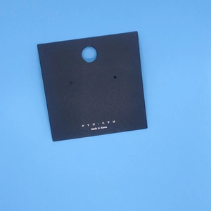 Square black jewelry earring display card with silver nyunyu logo on blue background
