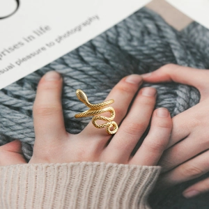 Adjustable gold snake ring featuring realistic scale texture and a minimalist wrap design