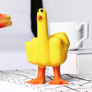 Detailed close-up of a funny yellow resin duck figurine showing a middle finger gesture