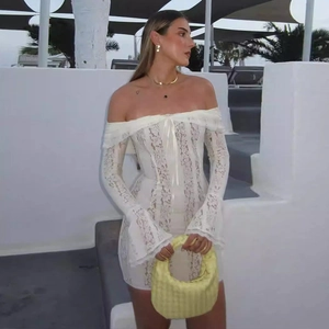 Detail of white lace off-shoulder dress with flared sleeves and lace-up front detail