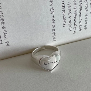 925 sterling silver adjustable heart ring with Love engraving on a vintage book