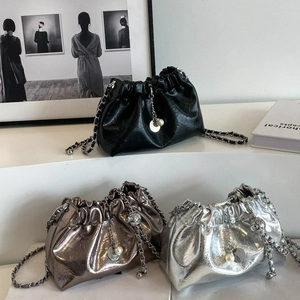 Three pleated cloud bags in black, silver and bronze with metal chains and pearl charms