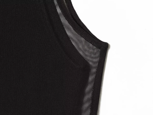 Close-up of high-quality black mesh fabric detailing with fine sewing on a double layer dress